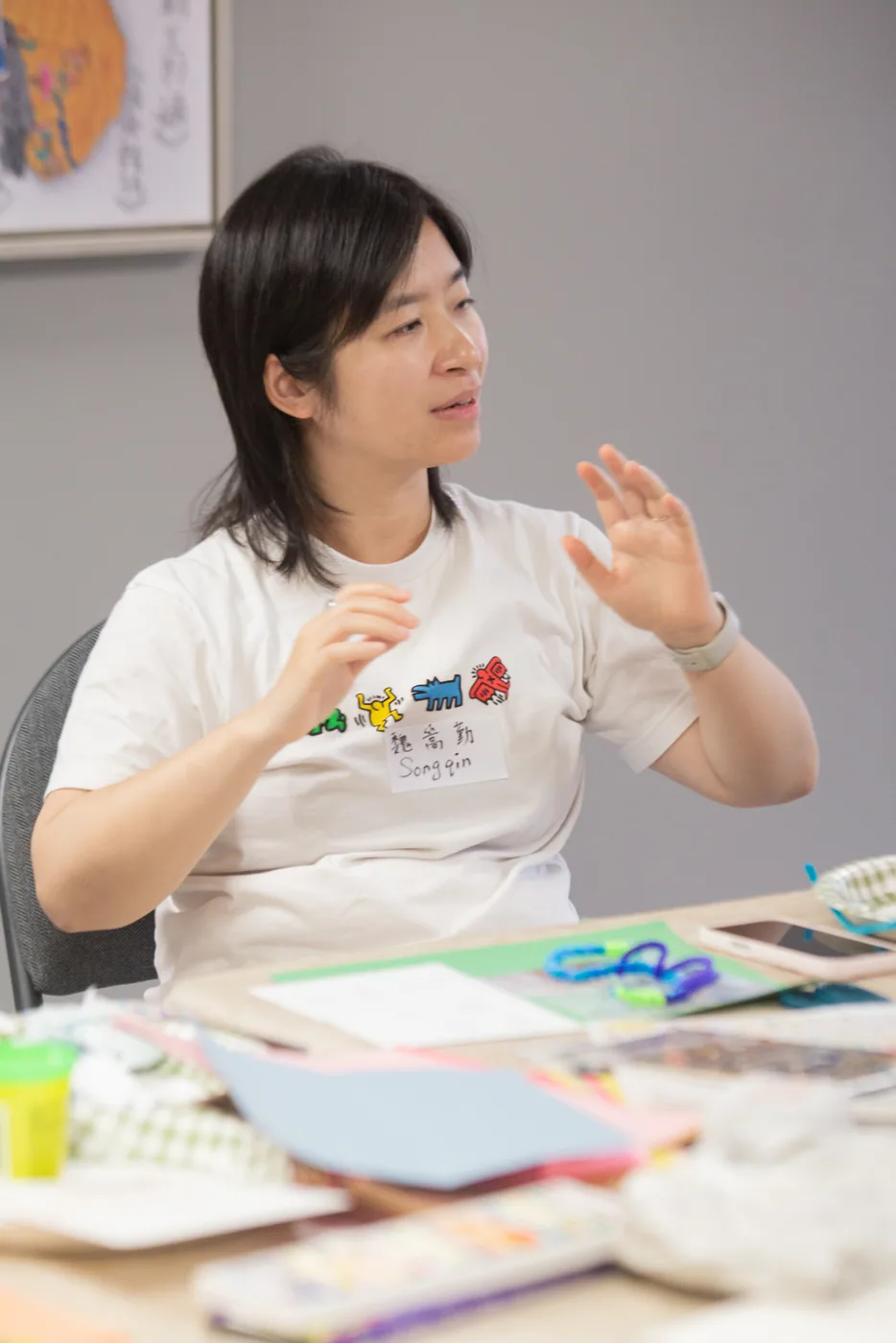 A group facilitator gesturing while guiding a creative activity